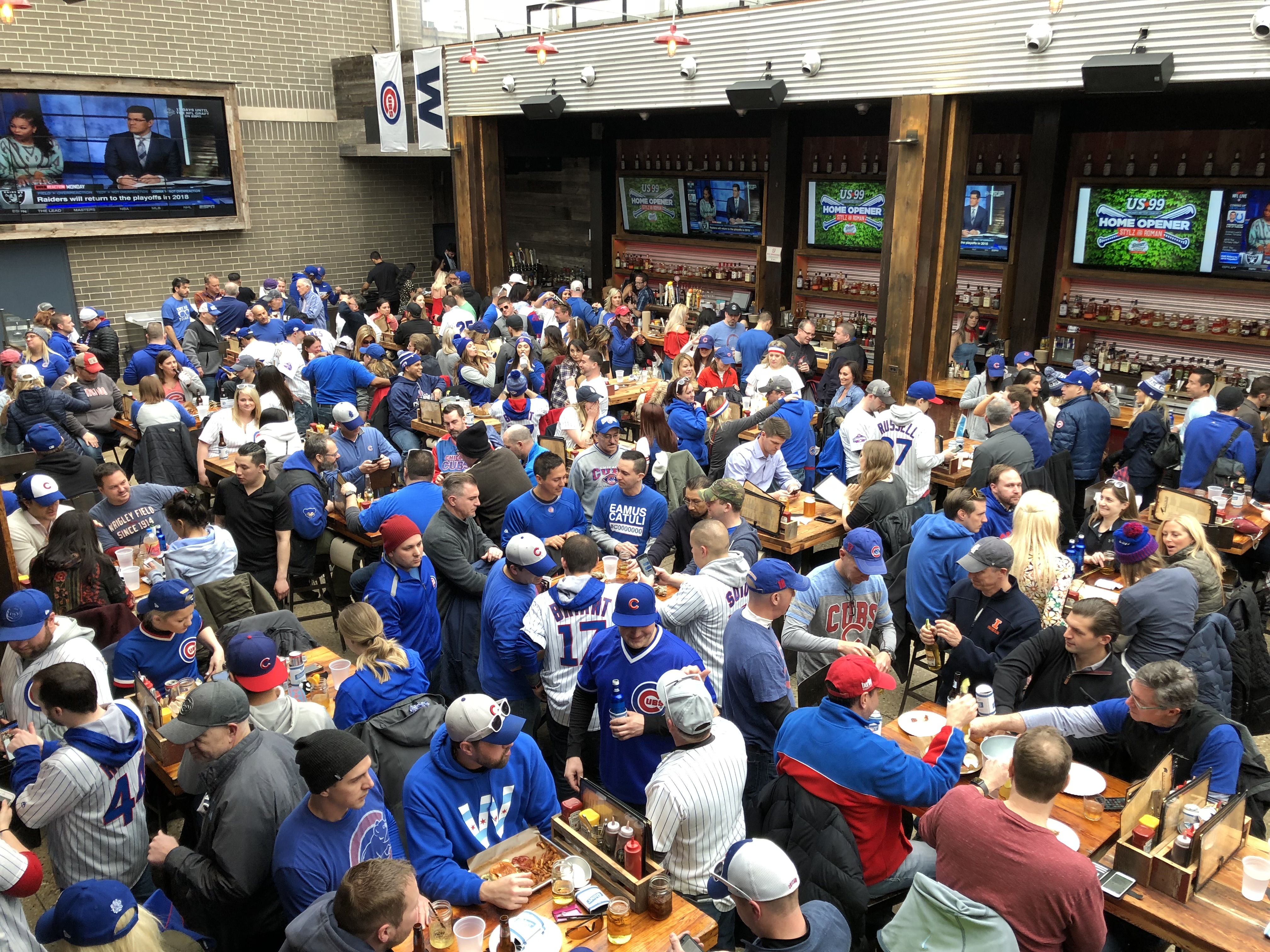 Rooftop on a game day, communal tables and bar